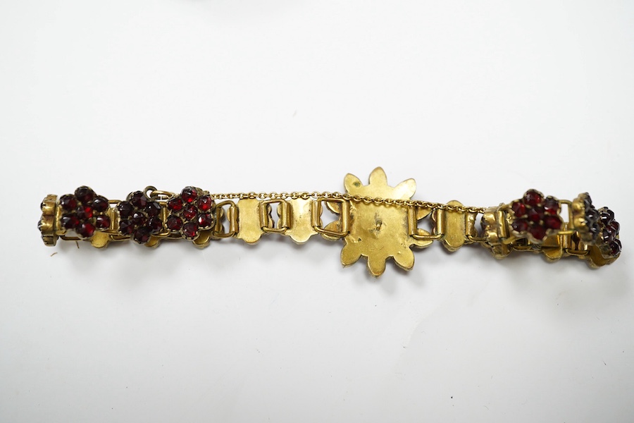 Three items of gilt white metal and garnet paste cluster set jewellery, comprising a bracelet, bangle and pair of Czechoslovakian earrings. Condition - fair